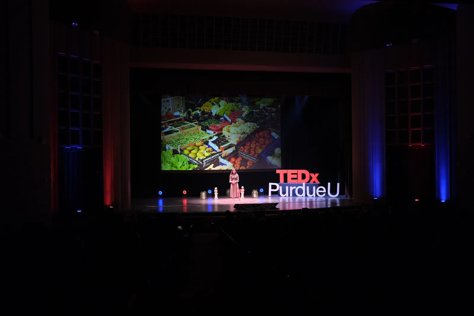 A student speaker on the Loeb Playhouse stage